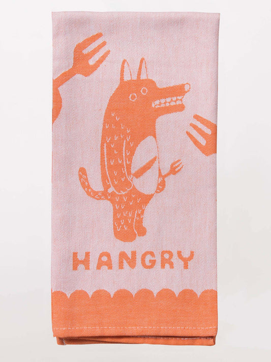 The Blue Q Hangry Dish Towel features a pink and orange cartoon animal with wolf utensils, surrounded by forks, and "HANGRY" boldly printed below.