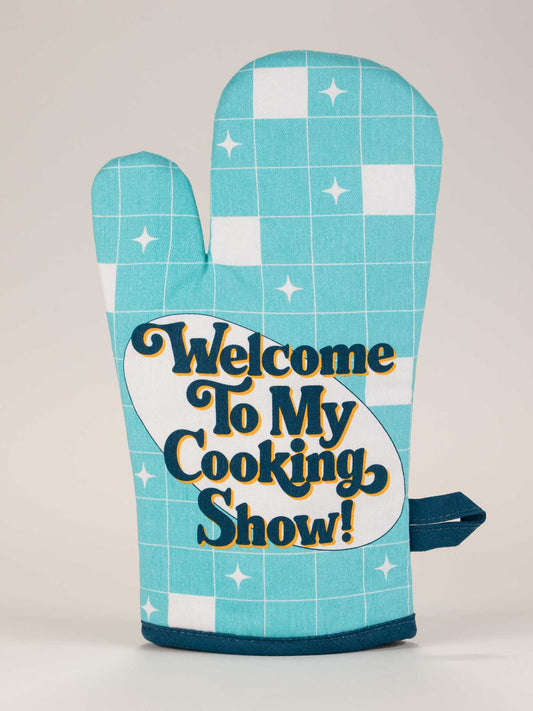 The Blue Q "Welcome To My Cooking Show!" Oven Mitt features blue and white checks with the bold phrase printed on the front, inspired by The French Chef Julia Child.