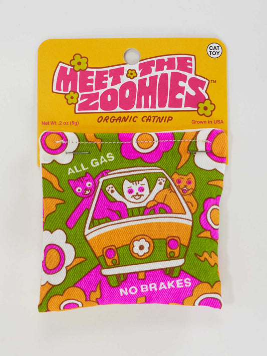 Blue Q’s Meet The Zoomies Catnip Toy features cartoon cats driving a car with “All Gas No Brakes” on a flower-patterned package, offering healthy play with premium organic catnip.