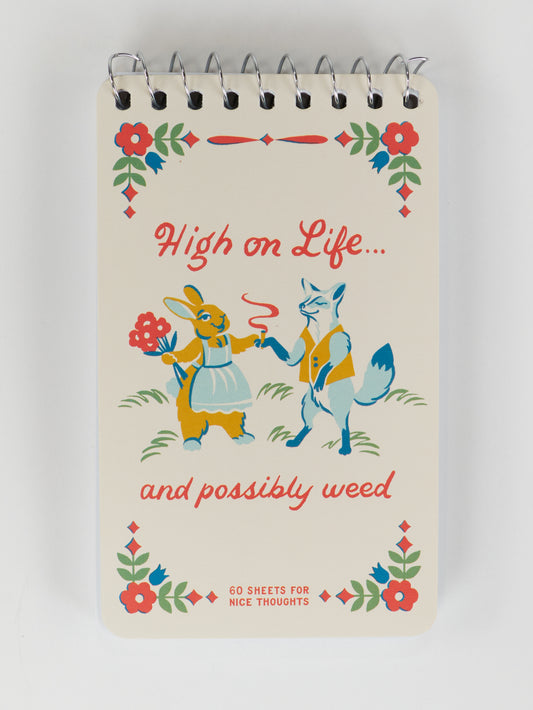 The Blue Q "High On Life...And Possibly Weed" 3x5 spiral notebook features vintage art of a rabbit and fox (the fox holds a joint and lighter), framed by florals. Fun cover text makes it a playful, pocket-sized ideas notebook.