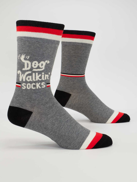 Blue Q's Dog Walkin' M-Crew Socks are gray cotton with black, white, and red stripes, "Dog Walkin Socks" text, and a small antler graphic—perfect men's socks for all your walkies adventures.