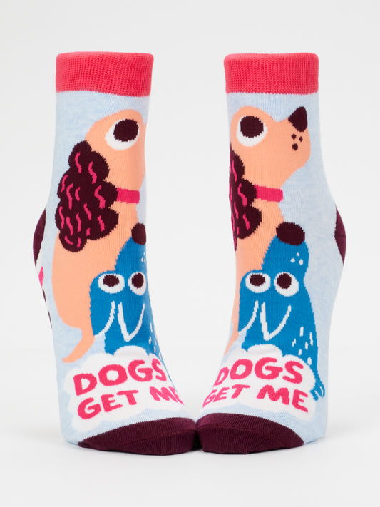 Show off your quirky style with the Blue Q Dogs Get Me W-Ankle Socks! These playful ankle socks feature charming cartoon dogs plus the bold phrase “DOGS GET ME” on a light blue background with fun pink accents. Perfect for women or any dog lover who enjoys novelty socks and showing off their love for pups.