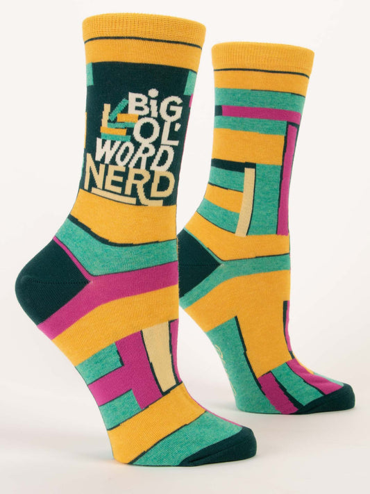 Blue Q's Big Ol' Word Nerd W-Crew Socks feature bold yellow, green, purple, and cream geometric designs. Made from soft combed cotton and spandex, one sock displays "BIG WORD NERD" in striking white and yellow letters.