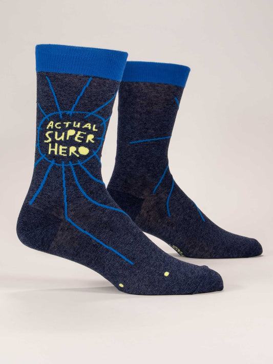 Blue Q’s Actual Superhero M-Crew Socks are dark blue everyday socks with blue cuffs, a comic-style design, and “ACTUAL SUPER HERO” in yellow within a burst graphic on the side.