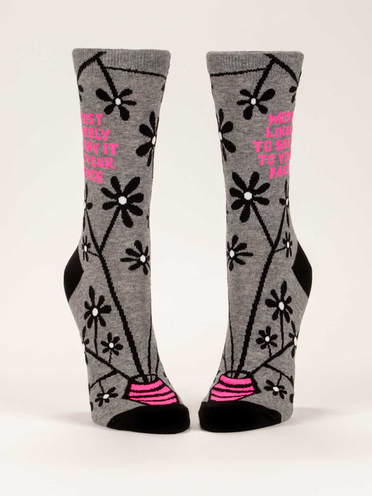 Blue Q's Most Likely To Say It To Your Face W-Crew Socks are gray combed cotton with black flowers and pink toes, plus pink text reading “MOST LIKELY TO SAY IT TO YOUR FACE.”.