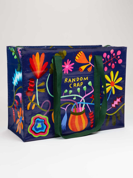The Blue Q Random Crap Shoulder Tote features colorful floral designs, green handles, and "RANDOM CRAP" on the front—ideal for groceries or organizing everyday essentials.