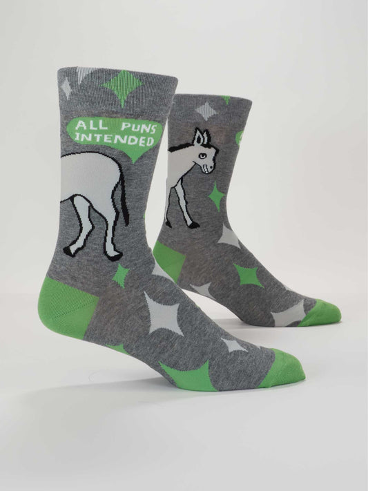 Blue Q’s All Puns Intended M-Crew Socks feature gray combed cotton, a cartoon donkey, green and white stars, and the phrase “ALL PUNS INTENDED” in a green speech bubble for a fun, comfy style.