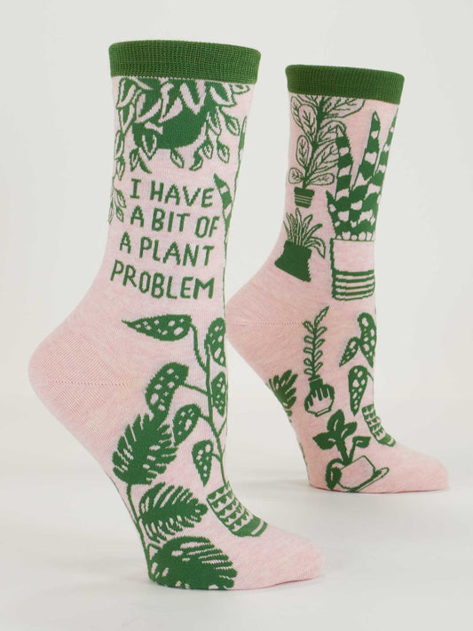 Blue Q’s “I Have A Bit Of A Plant Problem” W-Crew Socks feature pink combed cotton, green accents, potted plants (like monstera), and bold side text. Fits most women's shoe sizes.