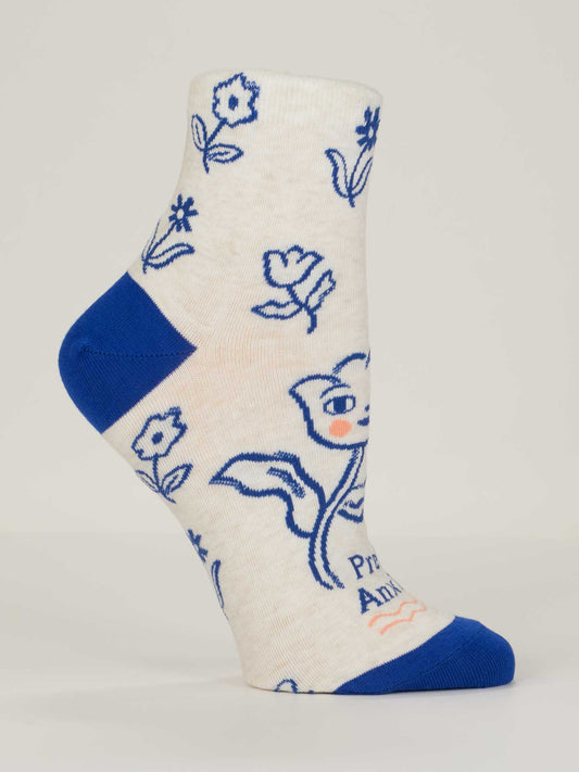The Pretty Anxious W-Ankle Socks by Blue Q are cream-colored women’s socks in combed cotton, with blue toe and heel, blue floral line art, and a cartoon fox with a flower. Fits shoe size 5-10; partial small text near the toe.
